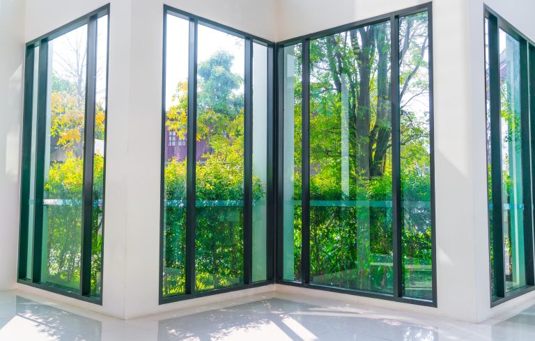 Glass window overlooking green garden 